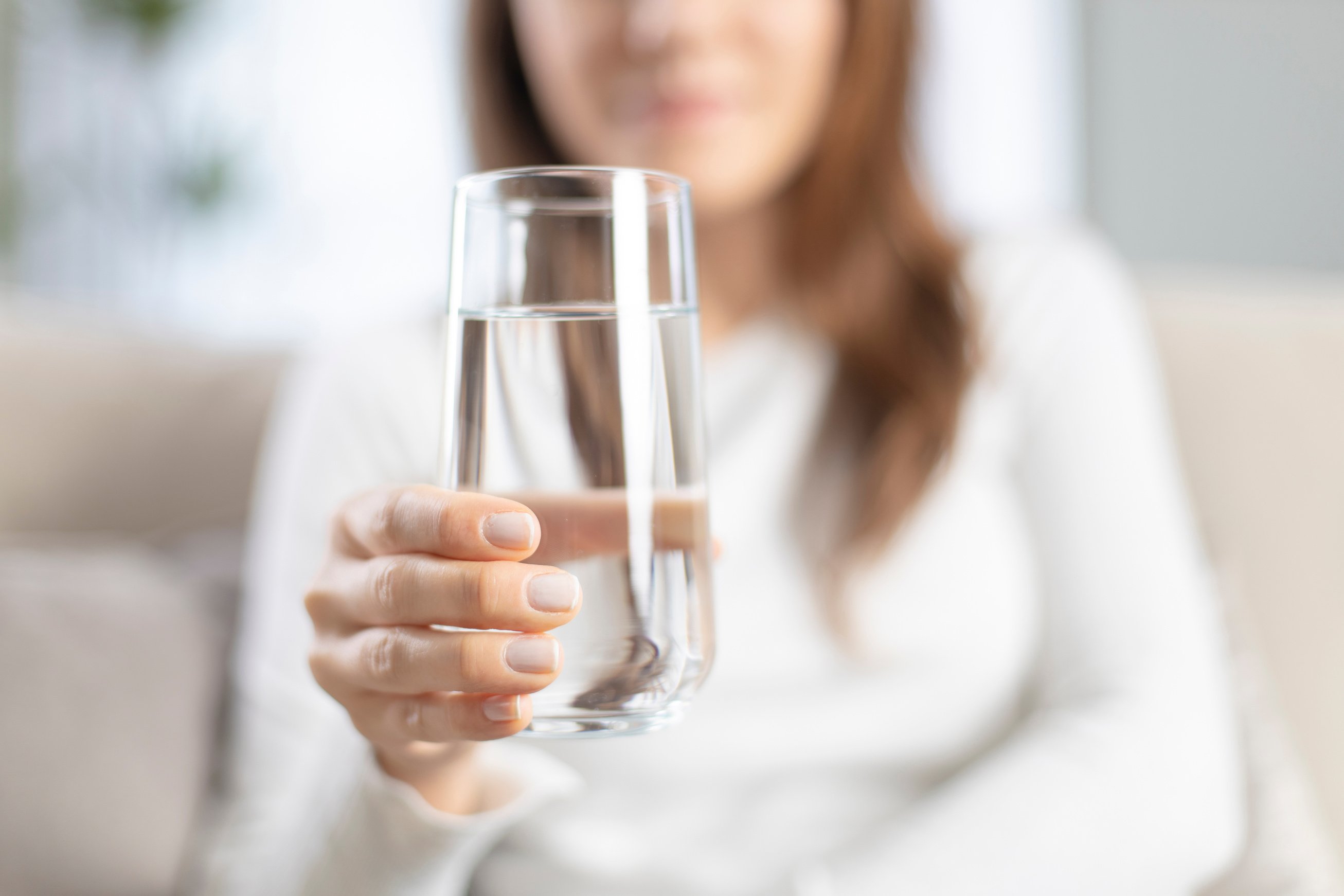 Woman drinking water at home